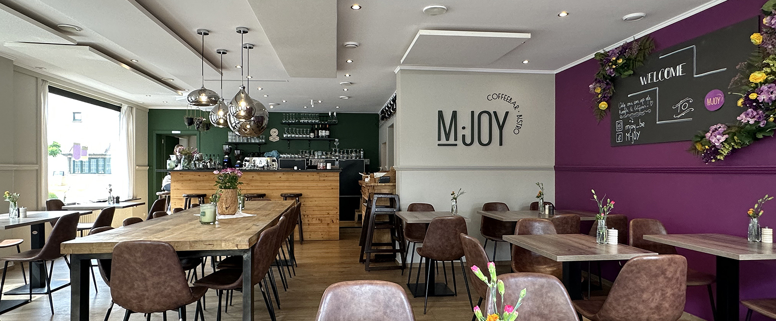 Interior of M.JOY Coffeebar & Bistro with tables and chairs